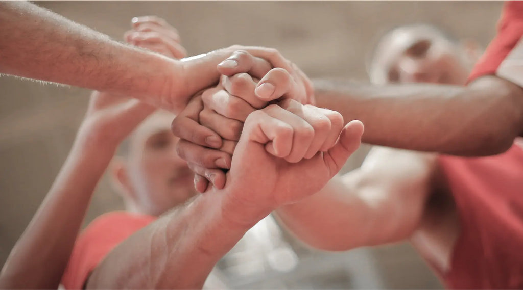 Team huddle with hands piled on top of each other