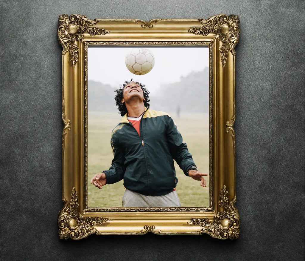 Golden ornate photo frame on wall with photo of soccer player